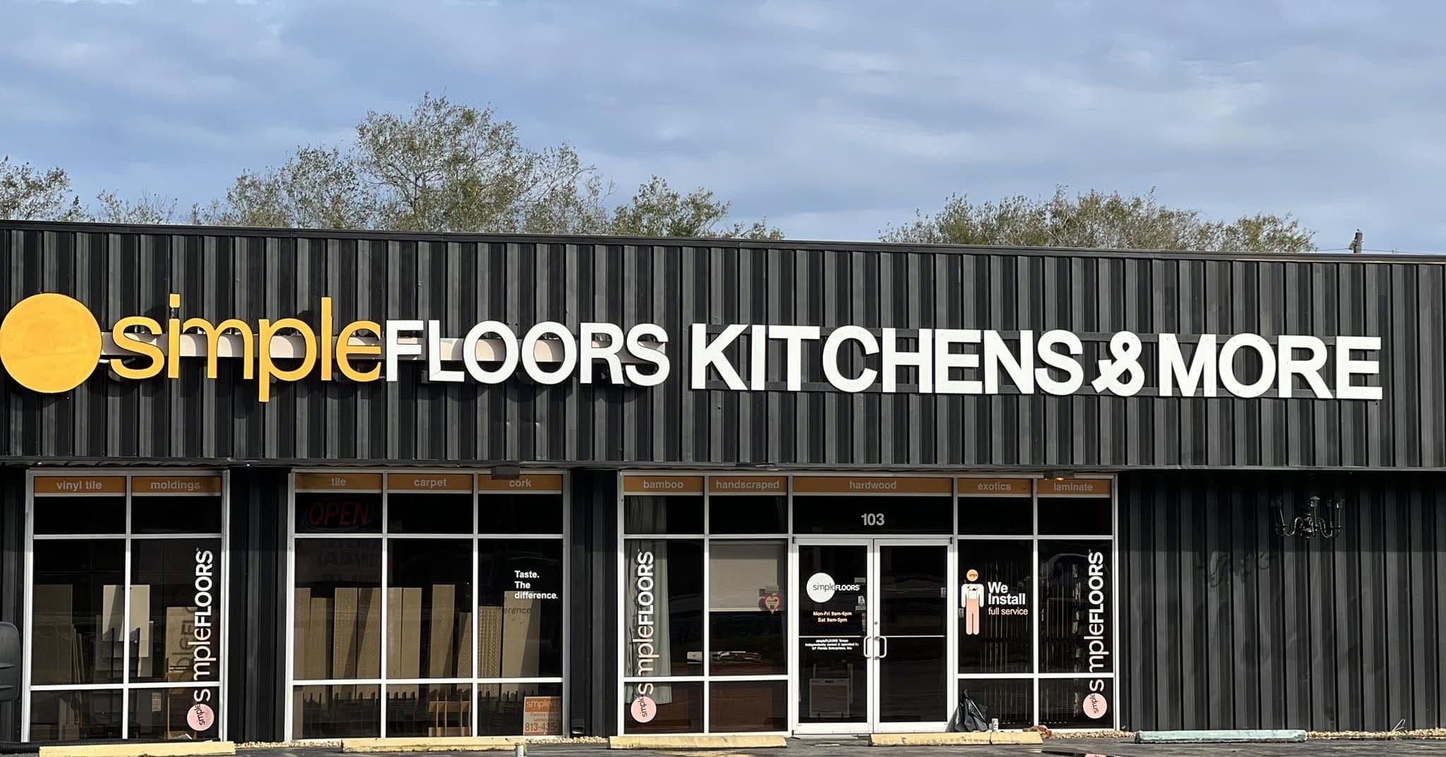 Storefront of Simple Floors Kitchens and More featuring large glass display windows.