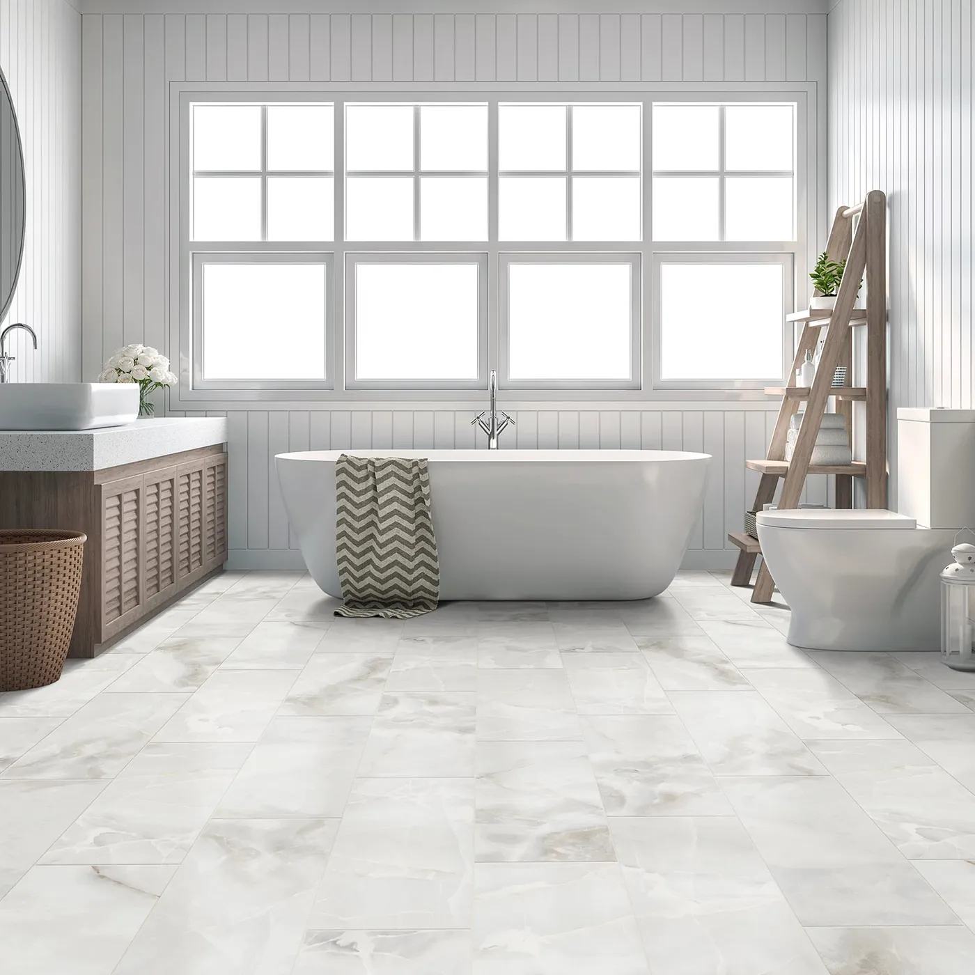 White bathroom with a free-standing tub and marble tile flooring
