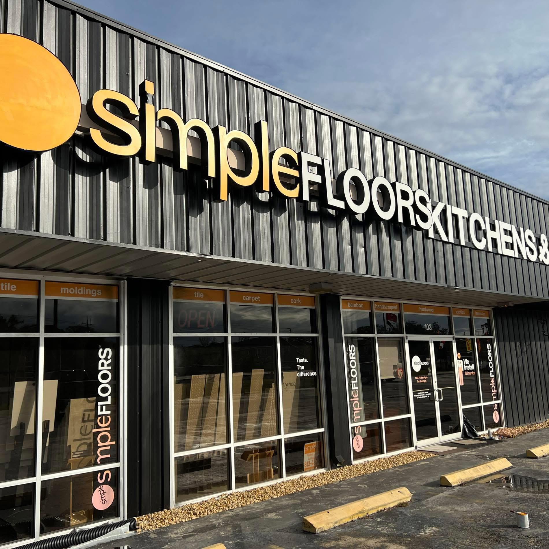 Storefront exterior of the Simple Floors Kitchens showroom with large display windows.