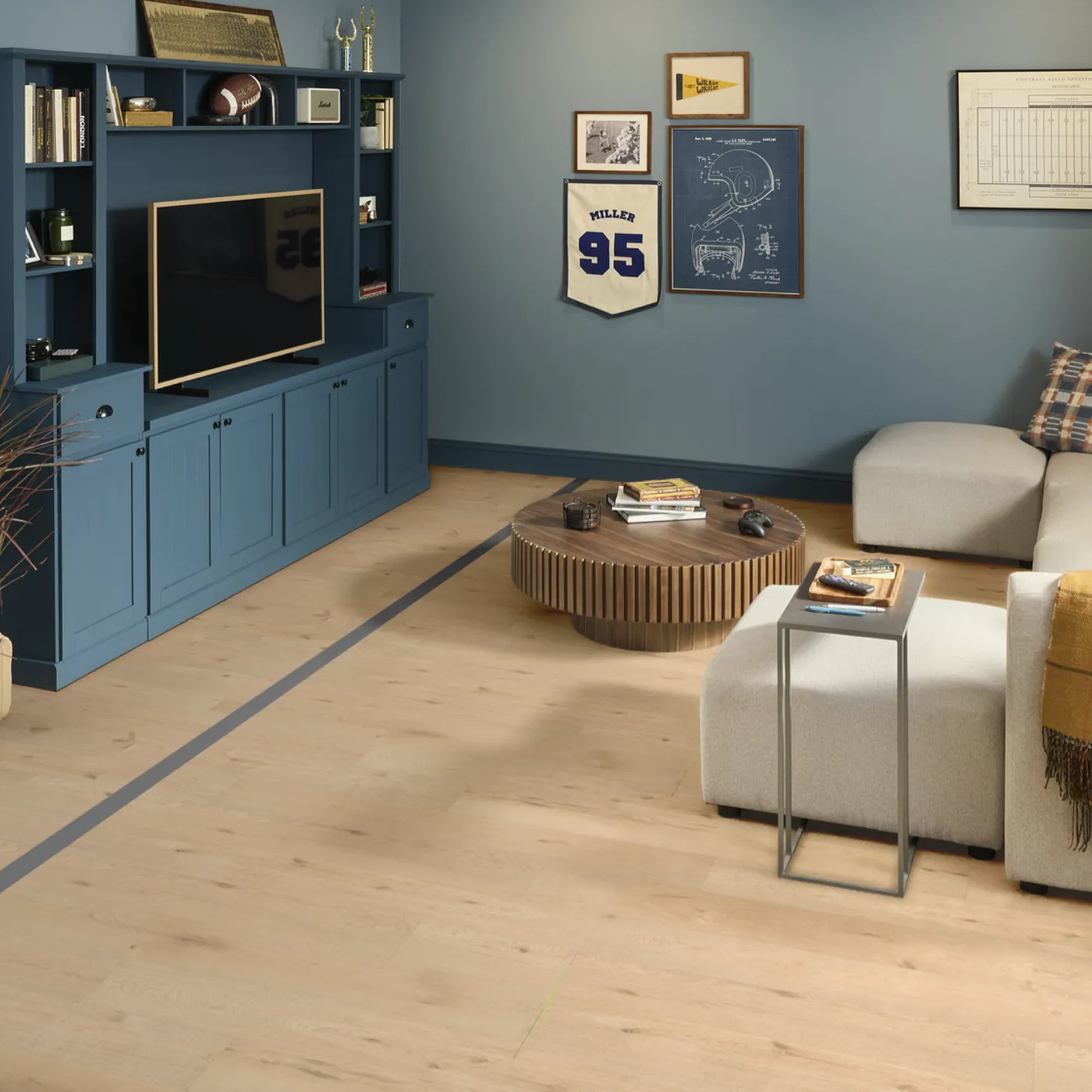 Light laminate flooring installed throughout a modern living room with blue walls.